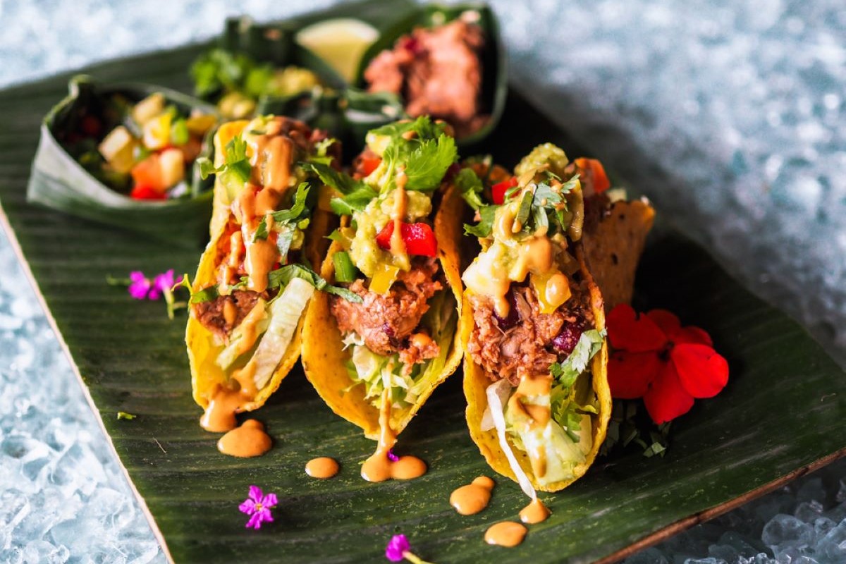 Jackfruit tacos with vegan hot sauce.