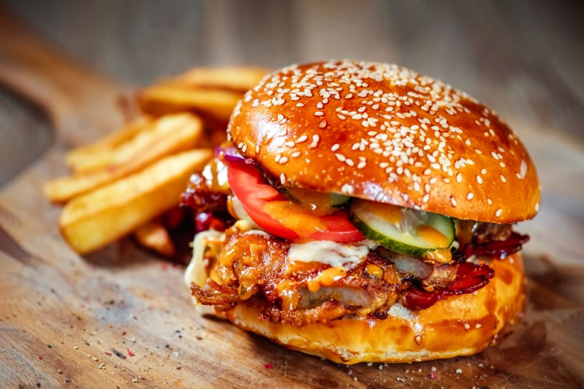 Grilled Burger With Fries On A Wooden Board.