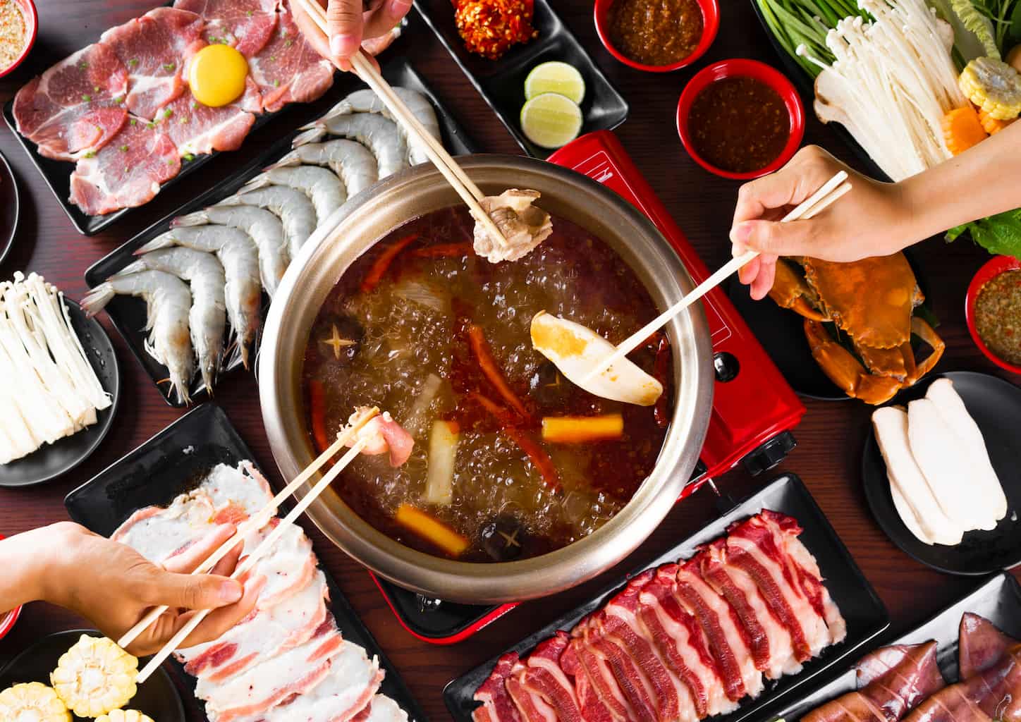 an overhead of two people enjoying a hot pot dinner